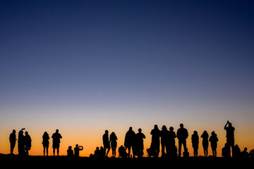 Fototapeta na wymiar Group of people at sunset