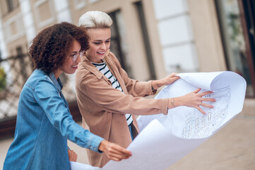 Design professionals busy analyzing a site development plan