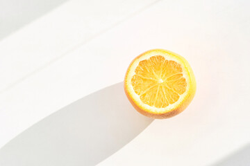 Summer coral orange slice. Citrus food diet. Fruit round juicy concept. Modern sweet cut photography. Bright color. Sunny piece creative design. Tropical vegetables. Summer vibe. Top view with shadows