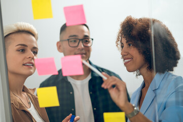 Joyful company employee sharing ideas with colleagues at the meeting