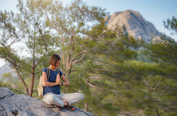 Naklejka na ściany i meble woman traveler walking by Lycian Way trail mountains in Turkey near Antalya. Woman meditating yoga alone in sunrise mountains. concept of spiritual relaxation for travel. Harmony with nature.