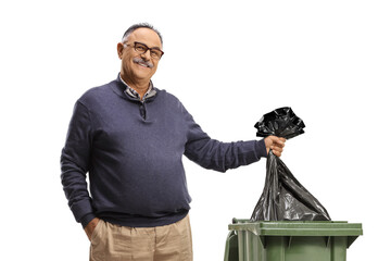 Mature man throwing a plastic bag in a bin