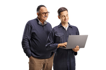 Male worker in a uniform showing a laptop computer to a mature man