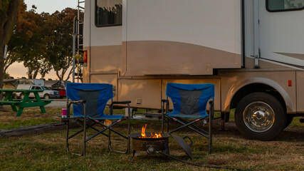 Rv camping sitting at fire pit 