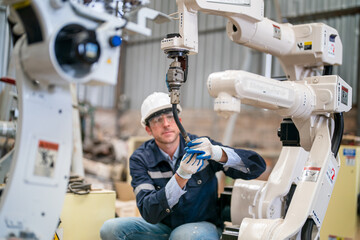 Robotics engineer fitting sensors to traditional engineering lathe in robotics research facility