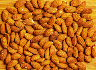 Pattern Organic almond nut raw peeled as background, top view. Healthy snack or for vegetarians.