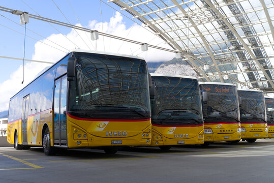 Bus station of Swiss Post Buses in a row at City of Chur, Canton Graub&uuml;nden, on a blue cloudy autumn noon. Photo taken September 26th, 2022, Chur, Switzerland.