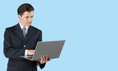 Happy young business man employee holding laptop