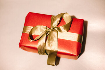 Christmas present. Red box wrapped with golden ribbon. Christmas gift