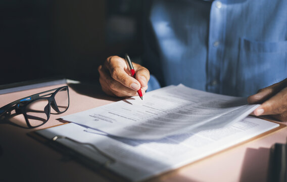 Close-up view on desk office, businessman reading a contract of investment or insurance, legal agreement before signing, Starting successful partnership with entrepreneur or companie