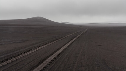 Fototapeta na wymiar Solo travel through the volcanic wilderness of Iceland on a foggy day.