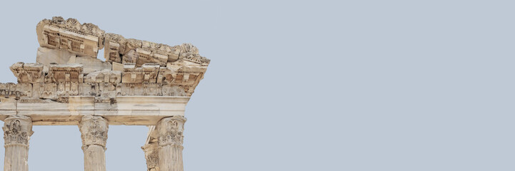 The Temple of Trajan in Pergamon Ancient City. Close up fragment of the entablature. Corinthian order. Isolated, banner, solid color background. History, art or architecture concept. Bergama, Turkey