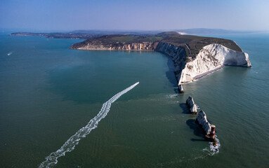 drone shot of peninsula with a boat in the sea