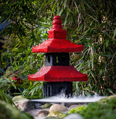 Asian temple decoration in garden surrounded by smoke