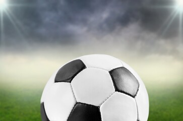 Fototapeta na wymiar Football or soccer ball at big stadium