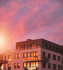 Sunset in a European middle house apartment. Concept of modern architecture for a better living. Contemporary medium-sized flat building in Europe