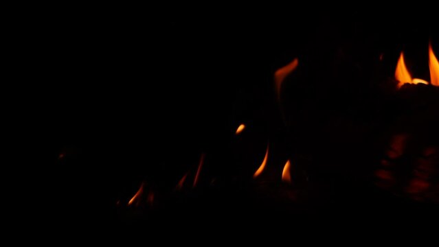 Fire burning at different spots lowly in darkness
