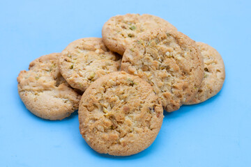 Pistachio and almond cookies on blue background.