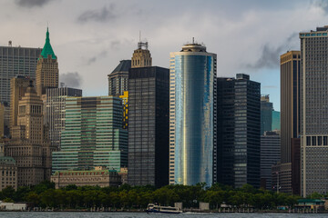 Fototapeta na wymiar The financial district in lower Manhattan in New York City with clouds in background.