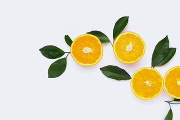 Orange fruit with green leaves on white background.