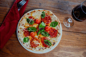 Pizza margarita with wine in a restaurant