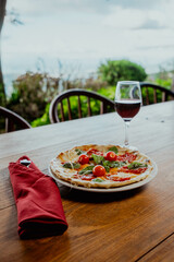 Pizza margarita with wine in a restaurant