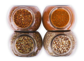 Powder spices in glass jars isolated on white