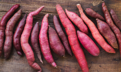 sweet potato organic purple closeup on wooden surface top view