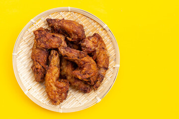 Fried chicken necks on yellow background.