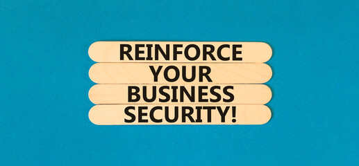 Reinforce your business security symbol. Concept word Reinforce your business security on sticks. Beautiful blue table blue background. Business reinforce your business security concept. Copy space.