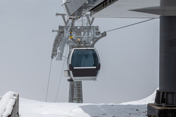 Gondola lifts on top of the mountain in winter