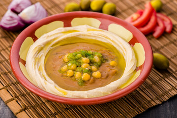 Hummus on it ful or fol with chickpeas served in dish isolated on table side view of arabic food