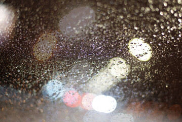 Blurred background with raindrops and lights.