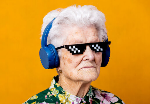 Stylish senior woman listening to music