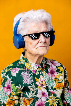 Stylish senior woman listening to music