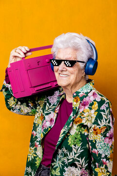 Optimistic aged meloman with boombox