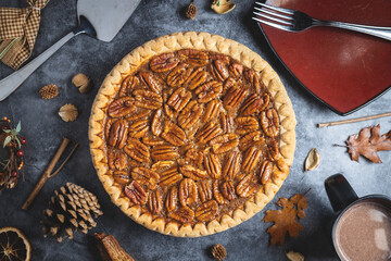 Top down pecan pie on a table with a mug of hot cocoa - obrazy, fototapety, plakaty
