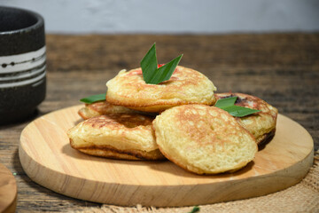 Kue Khamir or samir or Khamir cake on wooden plate. Khamir cake is a traditional snack from Pemalang, Indonesia. This cake is made from flour, butter and egg dough. Selective Focus