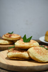 Kue Khamir or samir or Khamir cake on wooden plate. Khamir cake is a traditional snack from Pemalang, Indonesia. This cake is made from flour, butter and egg dough. Selective Focus