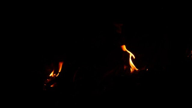 Fire burning singly from different spots in darkness