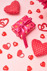 Valentines day frame with gift box and red hearts on a pink background. Valentines day banner