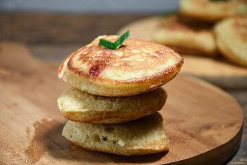 Kue Khamir or samir or Khamir cake on wooden plate. Khamir cake is a traditional snack from Pemalang, Indonesia. This cake is made from flour, butter and egg dough. Selective Focus
