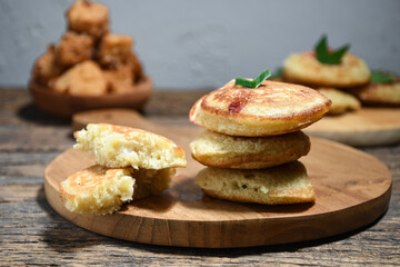 Kue Khamir or samir or Khamir cake on wooden plate. Khamir cake is a traditional snack from Pemalang, Indonesia. This cake is made from flour, butter and egg dough. Selective Focus