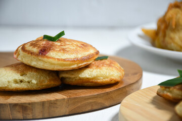 Kue Khamir or samir or Khamir cake on wooden plate. Khamir cake is a traditional snack from Pemalang, Indonesia. This cake is made from flour, butter and egg dough. Selective Focus