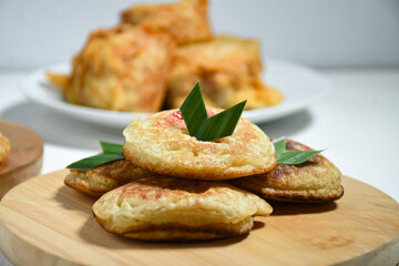 Kue Khamir or samir or Khamir cake on wooden plate. Khamir cake is a traditional snack from Pemalang, Indonesia. This cake is made from flour, butter and egg dough. Selective Focus
