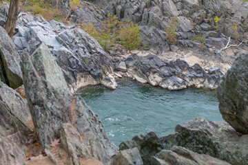 The rocky terrain and rushing rapids of Great Falls Park in Virginia as seen on a cloudy day.