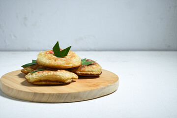 Kue Khamir or samir or Khamir cake on wooden plate. Khamir cake is a traditional snack from Pemalang, Indonesia. This cake is made from flour, butter and egg dough. Selective Focus