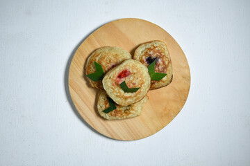 Kue Khamir or samir or Khamir cake on wooden plate. Khamir cake is a traditional snack from Pemalang, Indonesia. This cake is made from flour, butter and egg dough. Selective Focus