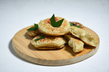 Kue Khamir or samir or Khamir cake on wooden plate. Khamir cake is a traditional snack from Pemalang, Indonesia. This cake is made from flour, butter and egg dough. Selective Focus