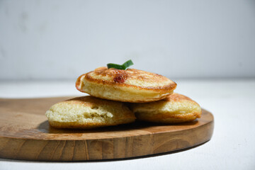 Kue Khamir or samir or Khamir cake on wooden plate. Khamir cake is a traditional snack from Pemalang, Indonesia. This cake is made from flour, butter and egg dough. Selective Focus